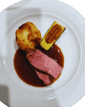 Stinco di vitello con jus al vino bianco, soufflé di polenta e zucchine ripiene