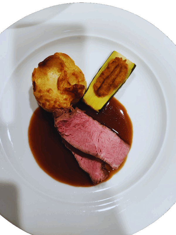 Veal shank with white wine jus, polenta soufflé and stuffed zucchini