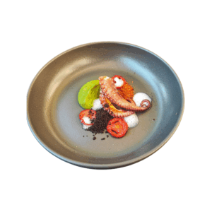 Roasted octopus with pea cream, oven-roasted tomatoes, and olive powder